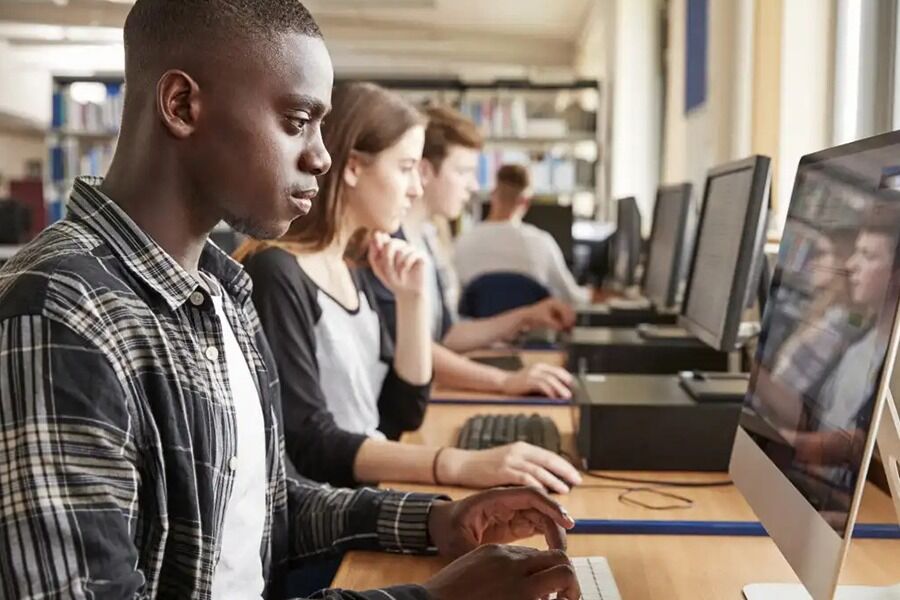 Students engaged in a focused classroom session, diligently working on computers concept image for education cybersecurity