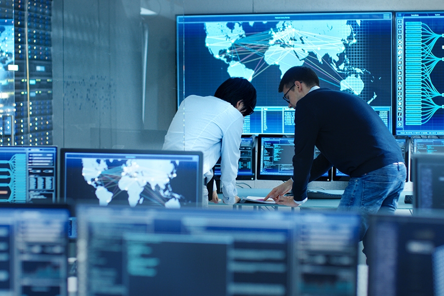 Cybersecurity expert monitoring network security in a control center.