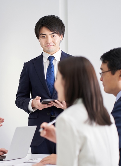 Japanese professional presenting IT consulting services in Japan during a team meeting Japanese professional presenting IT consulting services in Japan during a team meeting