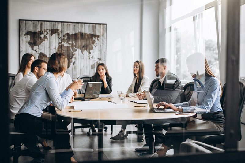 Team of business people discussing ROI IT strategy.