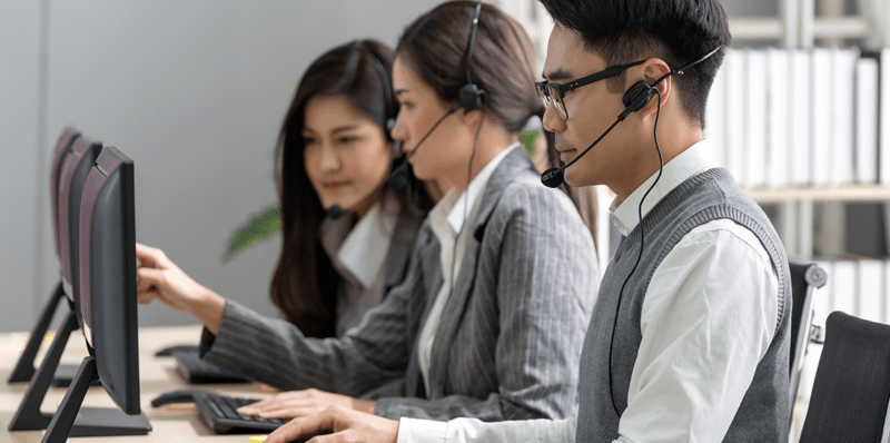Group of IT support personnel handling IT tasks and providing help Group of IT support personnel handling IT tasks and providing help