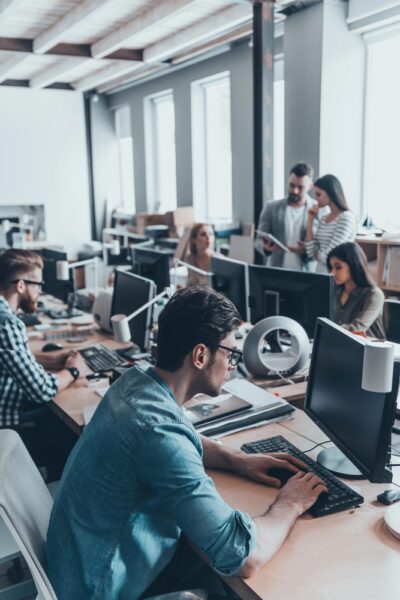 Singaporean business professionals collaborating in an office with optimized and secure Wi-Fi network, ensuring seamless connectivity and increased productivity