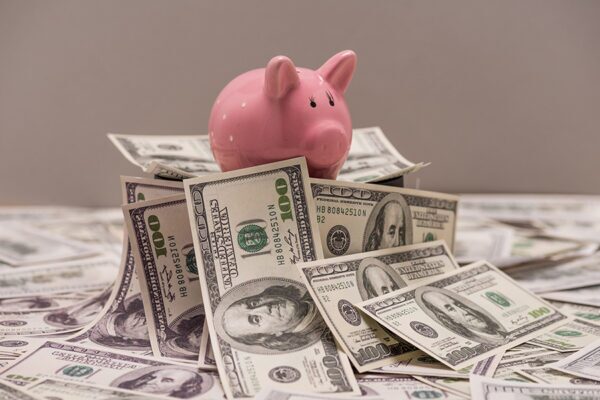 What Is a Technology Refresh, and Does Your Business Need One? 6 Piggy bank on top of money concept image for allocating budget for technology upgrade