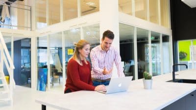 Six Benefits of Setting Up a Walk-In Tech Bar or Lounge 3 it support helping woman with laptop in a tech lounge