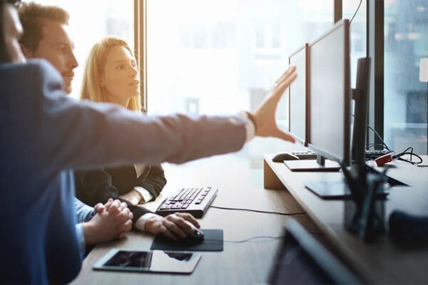 Maximize Your Resources: Outsourcing IT Projects for Success 2 Group of IT experts working on software development projects