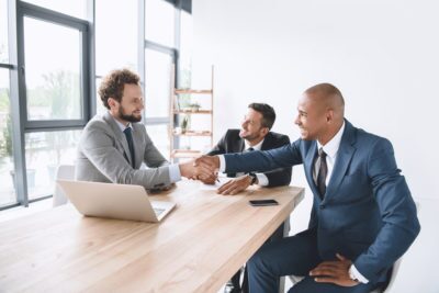 Where Should SMBs Start with Business Continuity and Recovery Planning? 2 Businessmen shaking hands - usiness continuity and recovery planning