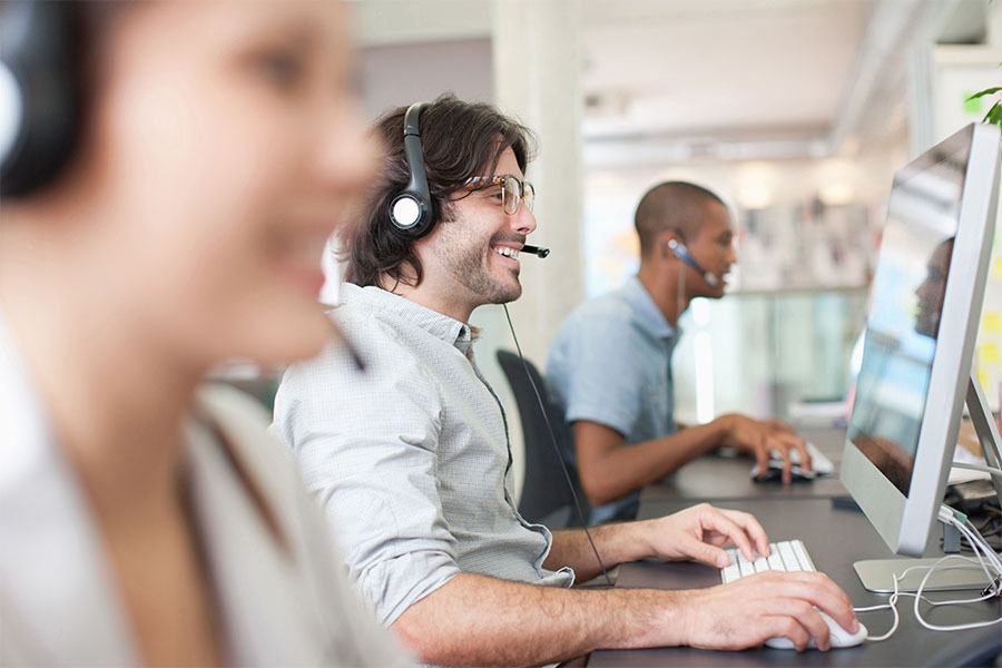 Tech support helping clients concept image for IT concierge services Tech support helping clients concept image for IT concierge services
