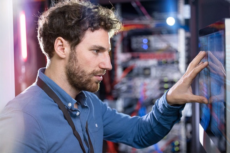 IT-technician-looking-at-the-WiFi-network-design. IT technician looking at the WiFi network design.