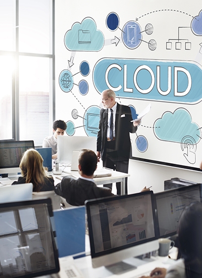 Azure Cloud Services in Japan 2 Business professional presenting cloud computing concepts in an office, highlighting Japan Azure Services with a collaborative team