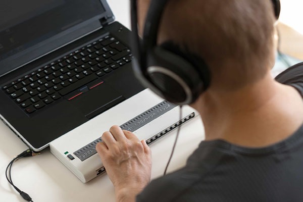 Man with disability using a screen reader.