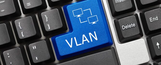 VLAN concept illustrated on a keyboard with a highlighted blue key labeled “VLAN” and a network diagram icon representing virtual network segmentation.